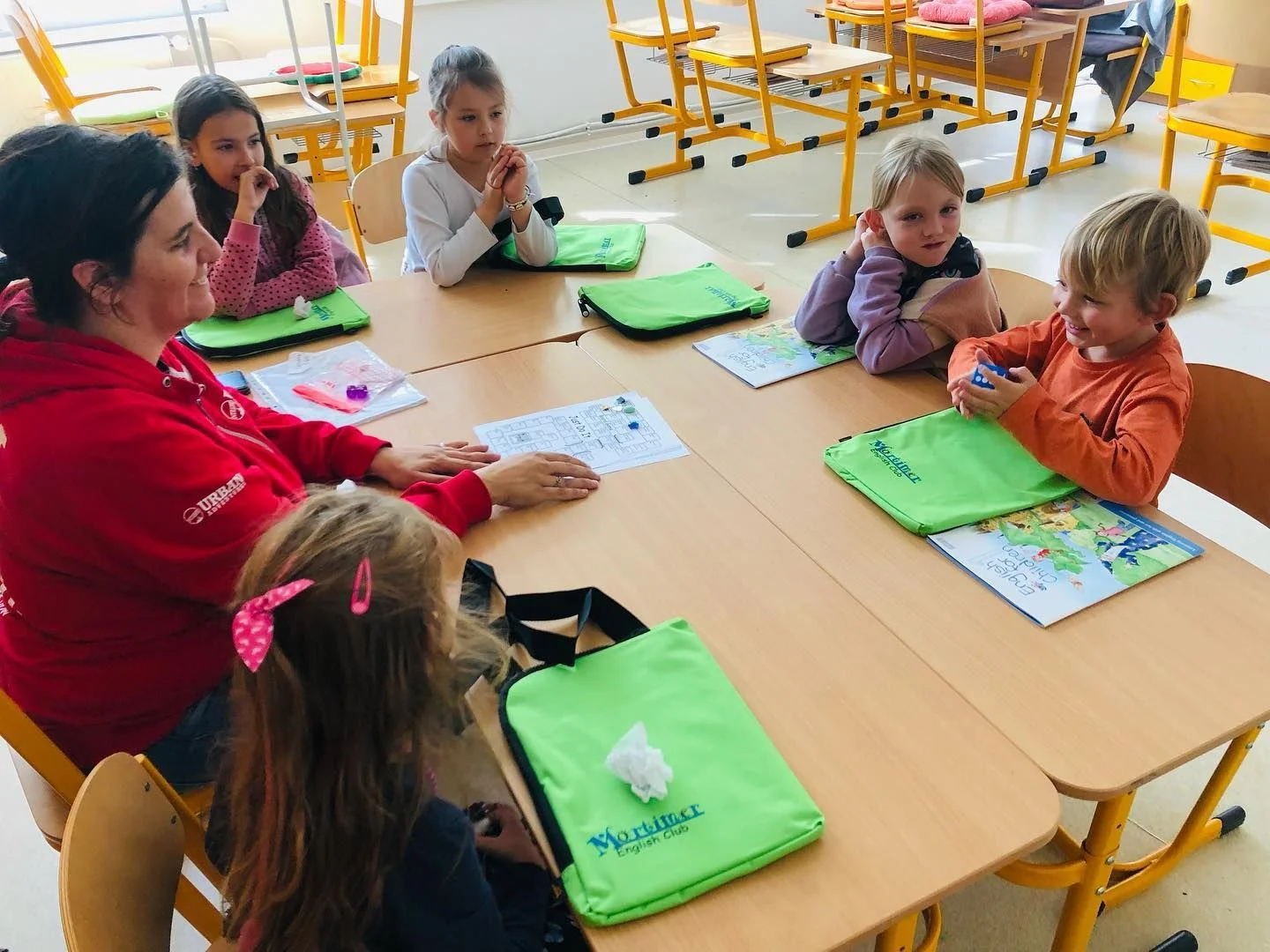 Lekce v malé skupině s lektorkou u společného stolu